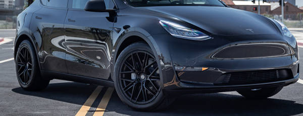 Tesla Model 3 parked with black Ennova rims.