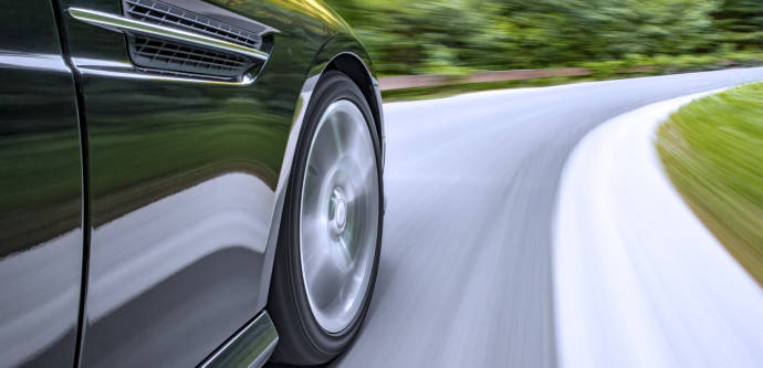 Close up of EV tire in motion on a curving road