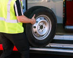 mobile tire installer moving a tire into a van