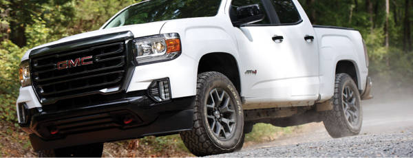 SUV with General Tires driving on rural dirty road