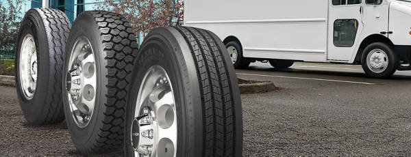 three commercial truck tires in a parking lot