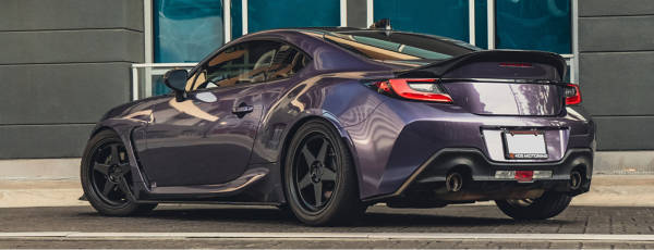 Sports sedan with Katana wheels parked on the side of the road.
