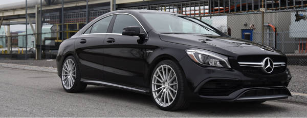 Mercedes C Class traveling on a city road.