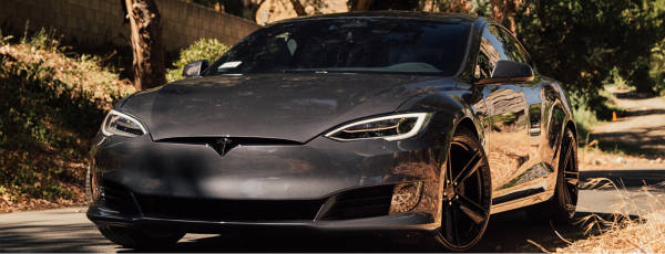 Tesla Model Y Parked on the side of the road with Range Finder tires.