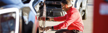 Tire technician inspecting a tire for damage