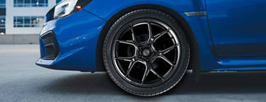 A close up image of a Yokohama YK-Series tire on a blue vehicle.